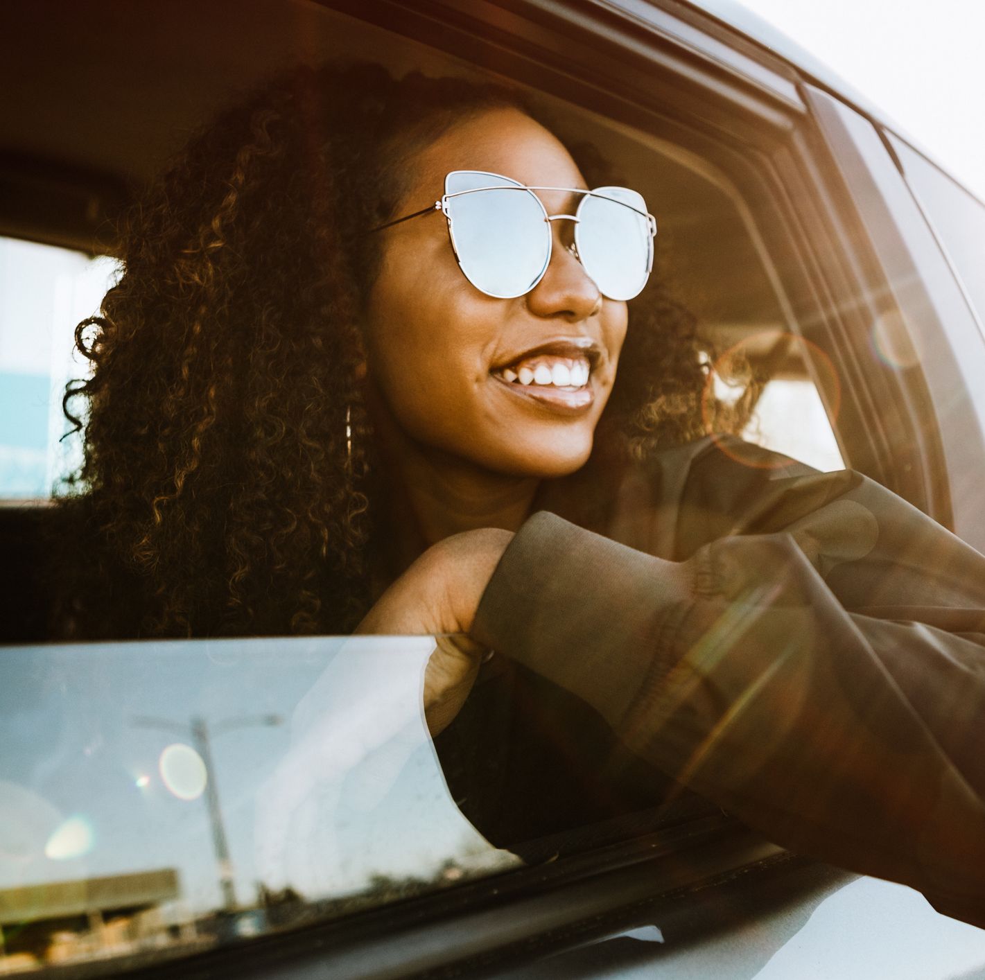 group of young adults having fun riding in car