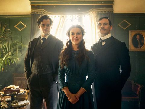 Enola Holmes stands between brothers sherlock and mycroft in a scene from Enola Holmes. The movie is a Good Housekeeping pick for best kids movies on Netflix enola holmes stands between brothers sherlock and mycroft in a scene from enola holmes the movie is a good housekeeping pick for best kids movies on netflix