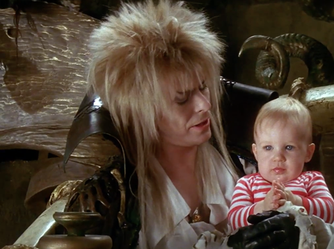 david bowie, as jareth the goblin king, holds baby toby in a scene from "labyrinth,' a good housekeeping pick for best halloween movies for kids