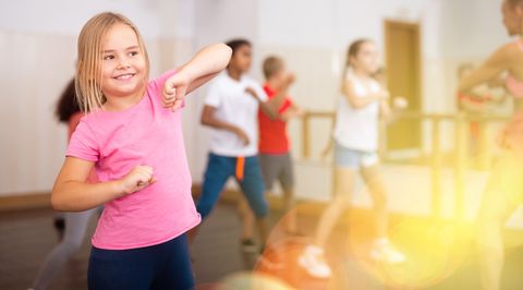 easter games - freeze dance girl exercising in group during dance class