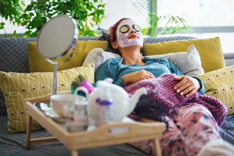 a relaxed teen with a face mask, cucumbers on her eyelids and other spa and makeover paraphernalia