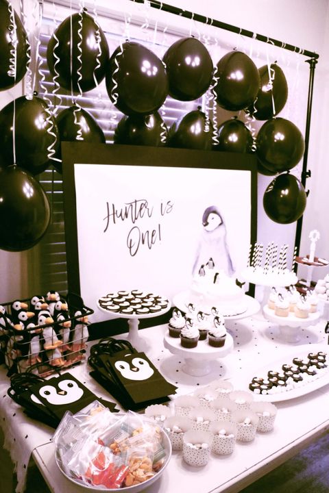 A penguin themed first birthday party includes penguin stuffies, goodie bags, cupcakes and other black and white treats a penguin themed first birthday party includes penguin stuffies, goodie bags, cupcakes and other black and white treats