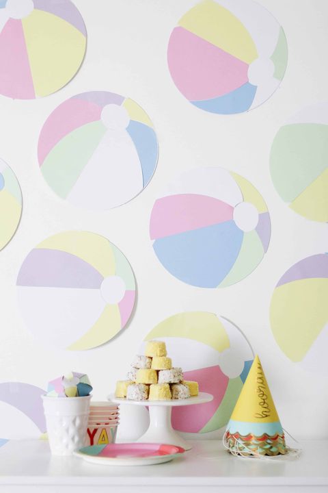 A beach-themed first birthday party includes beach ball décor a beach themed first birthday party includes beach ball décor