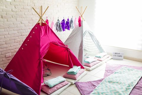 two teepee style tents are set up in a family room