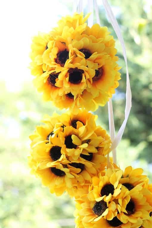 three hanging sunflower balls in the sunlight