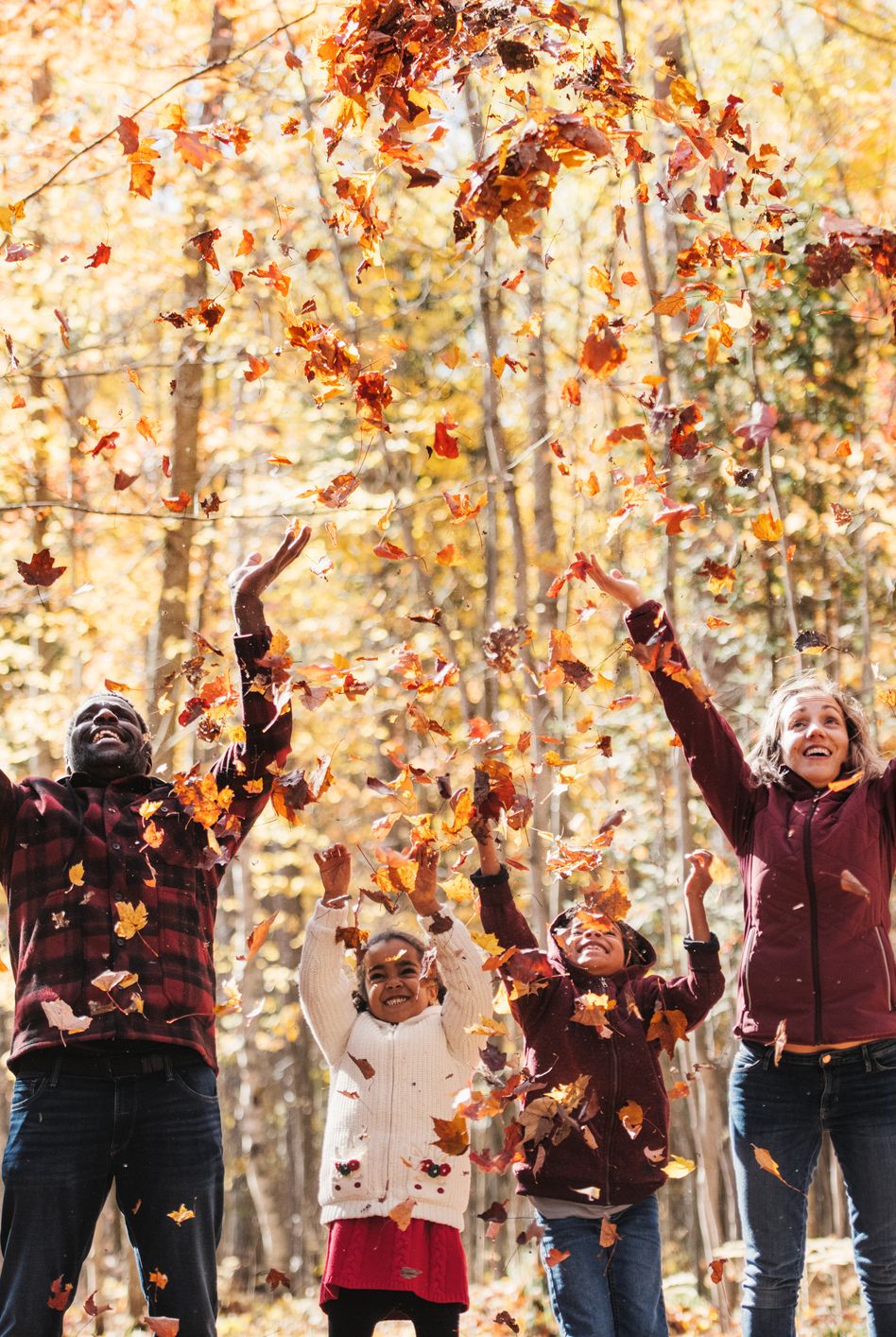 fall activities family throwing fall leaves